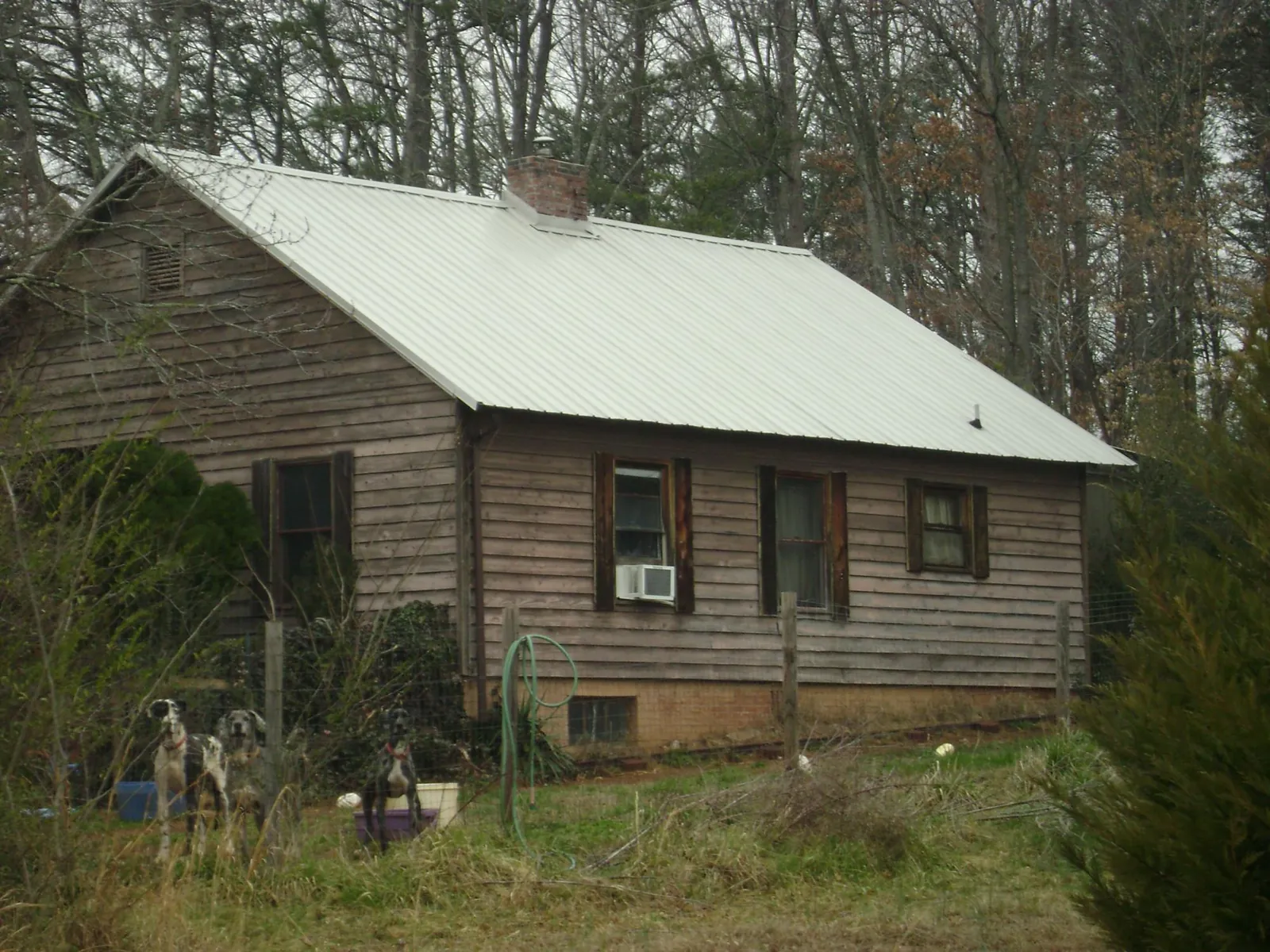 White metal roof on an old wood sided farmhouse, from a Metal Roof Installation job in New River